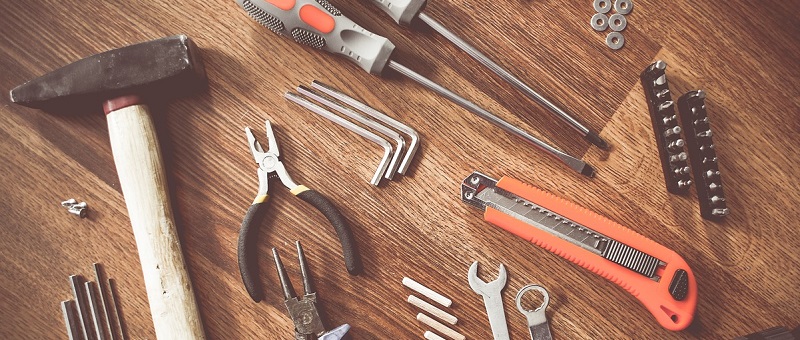 A variety of tools set out on a workbench