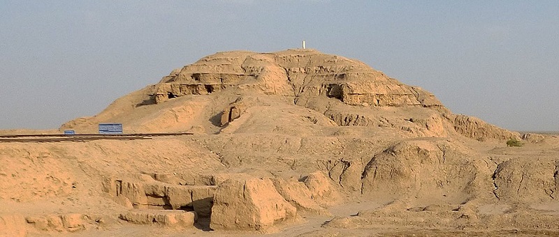 The remains of the White Temple of Uruk, a mound of half-melted bricks several dozen feet high, towering over the surrounding desert